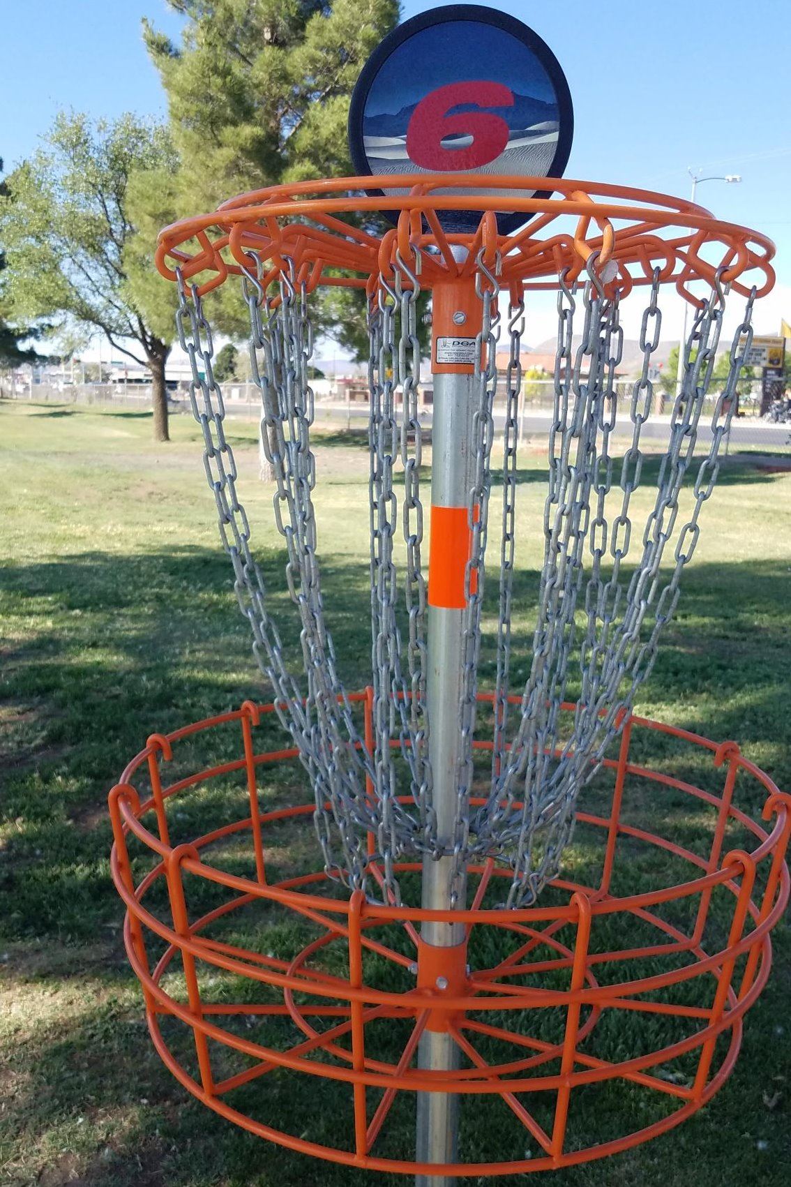 Disc golf tee basket number 6 in a park.