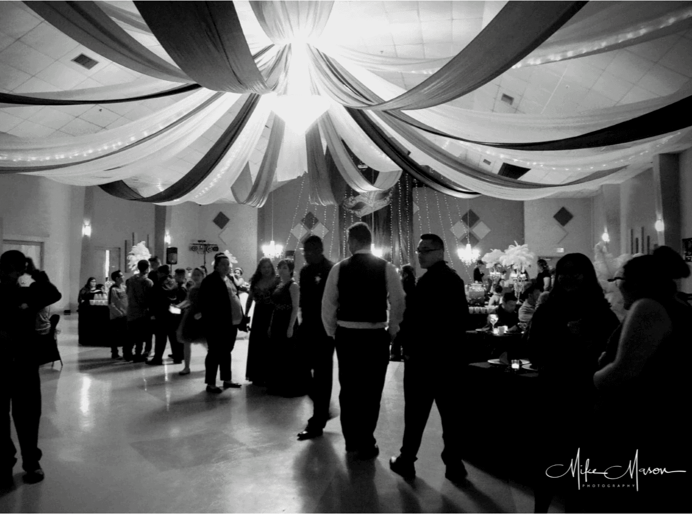 A black and white image of people at a party inside the Civic Center.